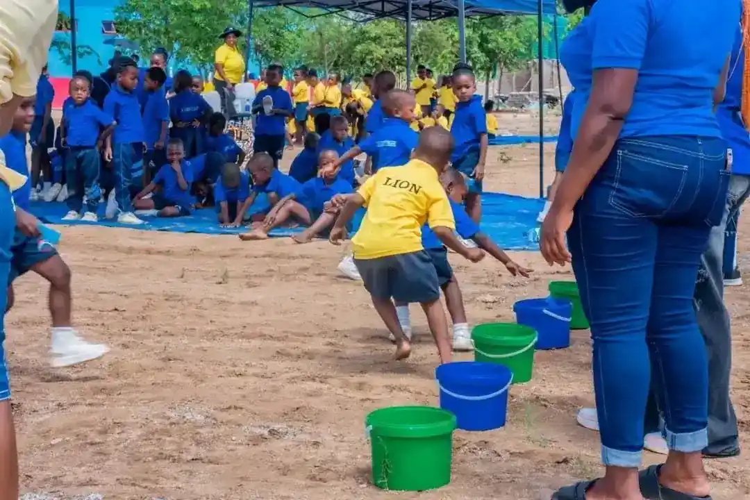 Children playing a bucket game outdoors